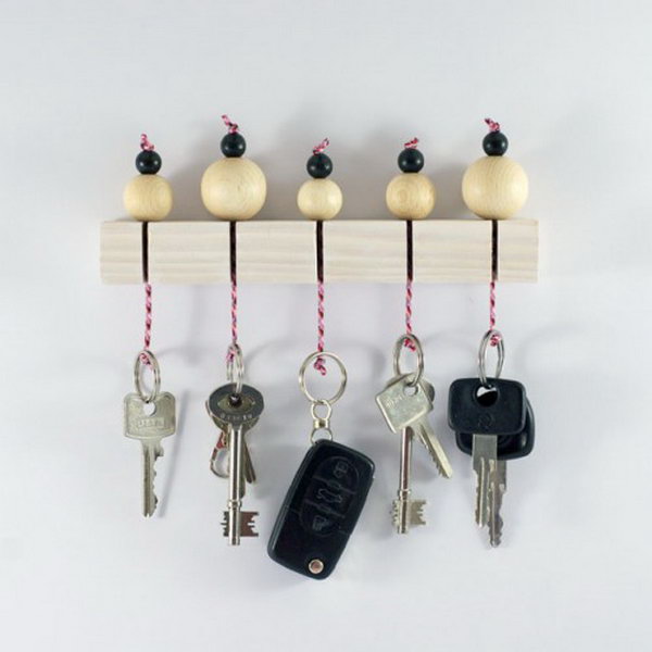 DIY Key Holder With Wooden Beads. Keys are always laying around, so having one central location with a little extra cuteness is a win-win!  Check out and create one super cute wooden beads key holder like this for your own 