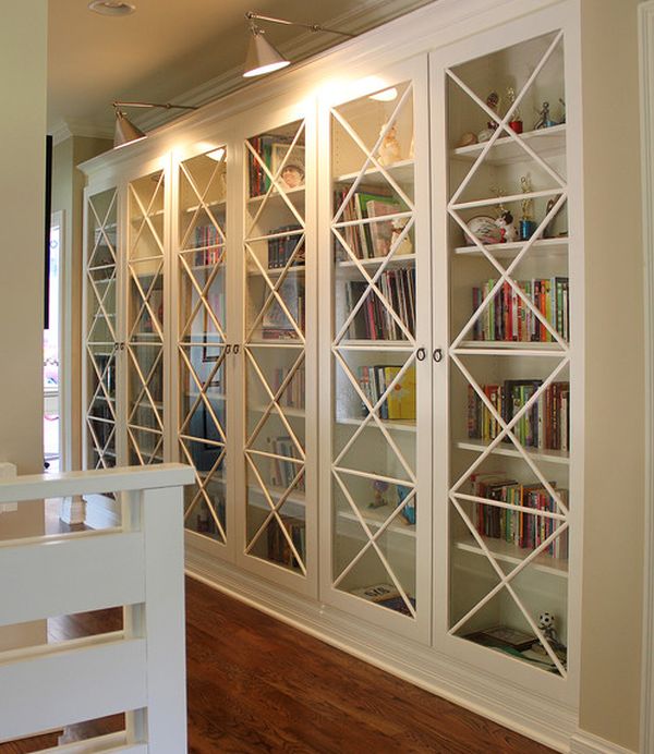  These X motif custom designed glass doors along with library lighting  give these bookcases an inimitable look. It is a simple way to ensure that your interiors stand out from the crowd. See more 