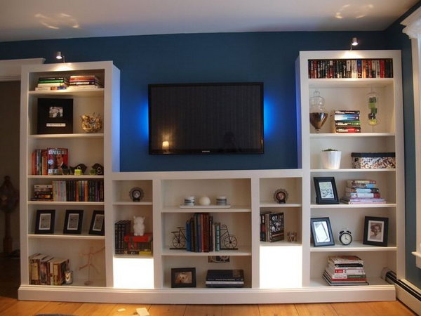  Simple and clever transformation of the IKEA BILLY bookshelves by  modifing and adding trim and lighting. Get a custom look for the living room. Get the directions 