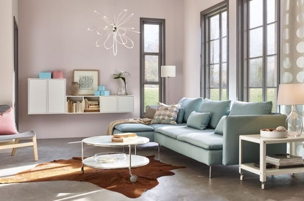 In this living room, the blue sofa matches the light pink painting wall very much. This color combination features a very peaceful and girly girl's living room. The light blue sofa from IKEA lay beside the window create more warmth and comfy to this living space. 