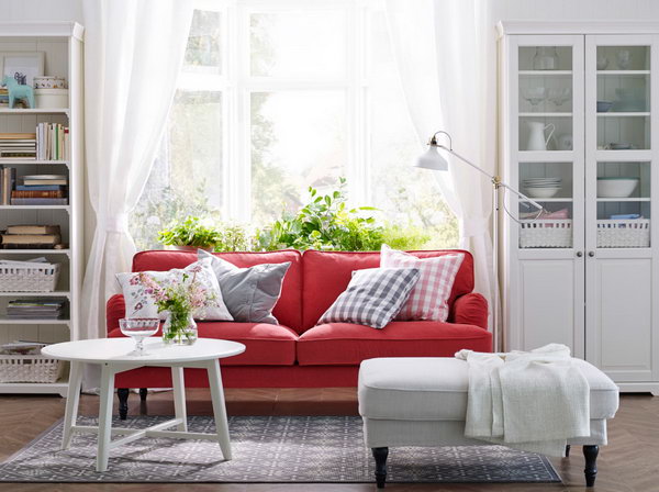 Red & White Living Room. Red is always related with passion. In this living room, the red sofa from IKEA adds more inviting and hospital feeling to this calm and classic white living space. The sofa is placed beside the window and the bookcase. You can enjoy the sunlight when do some reading here.