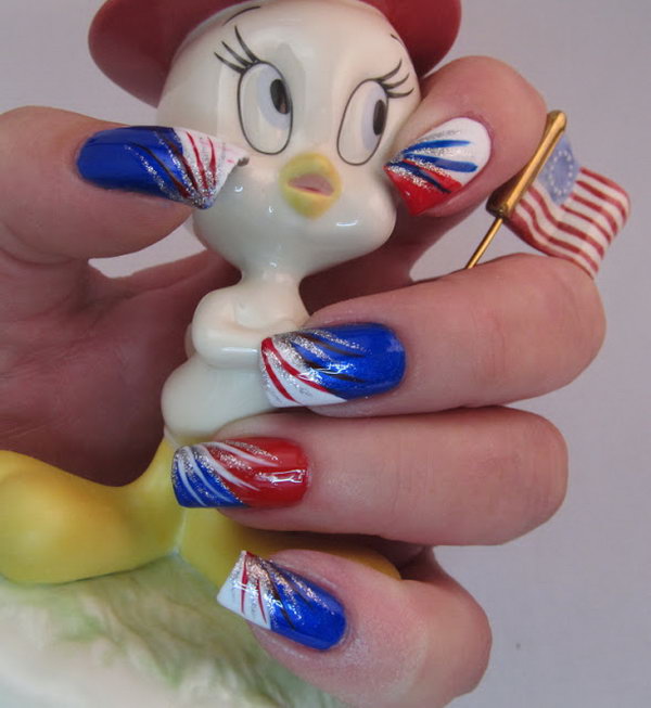 Red, White, Blue and Silver Stripes: This one is very easy to re-create. Apply a color to each nail and then paint a diagonal tip on each one. Add red, white, blue and silver stripes with brushes and it's done. See the tutorial