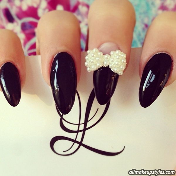 Elegant Black Nail Design with Pearl Bow.  