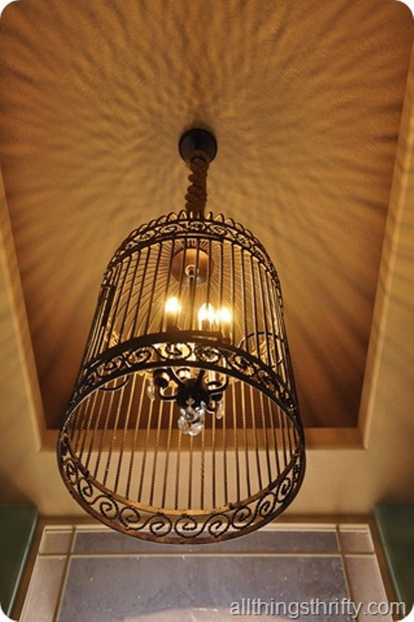DIY Gorgeous Birdcage Chandelier from a Large Birdcage. Instead of paying $2300 for this Restoration Hardware birdcage chandelier, the blogger made one from a small chandelier for $25.00 and a large bird cage for her entry way.