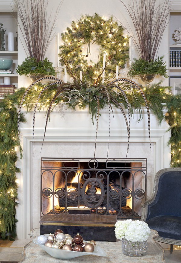 Hanging Green Christmas Wreath over White Wood Mantel with Green Leaves and Long Feathers on the Mantel 