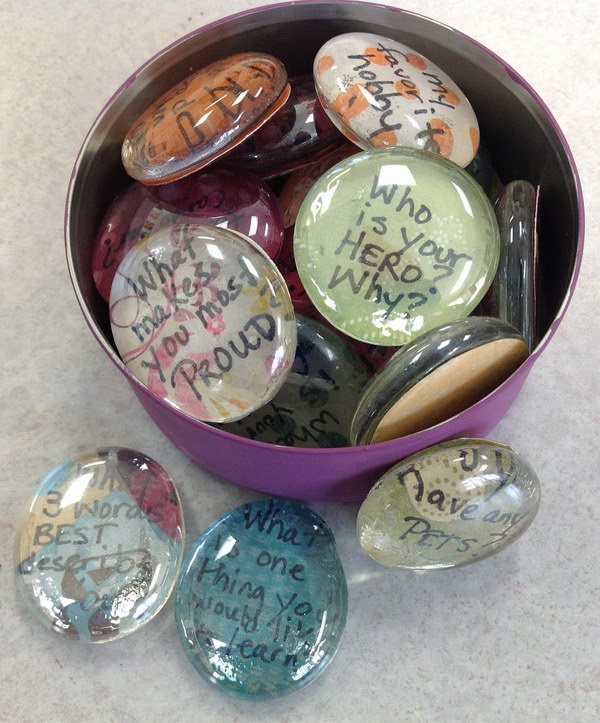 Icebreaker Question Stones. Use glass pebbles, scrapbook paper and Mod Podge to create some question stones. Give your icebreaker questions a new look. 
