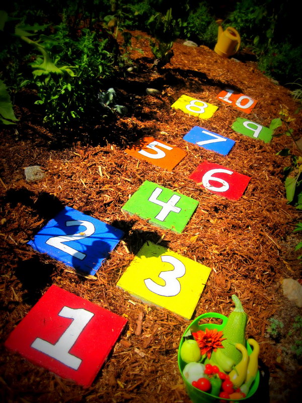 Painted Stepping Stones In Backyard For Hopscotch Game. 