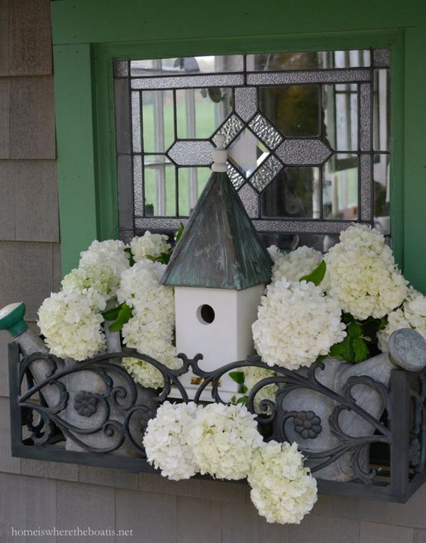 Potting Shed Window Box with Watering Cans, Bird House and Snowball Viburnum. 