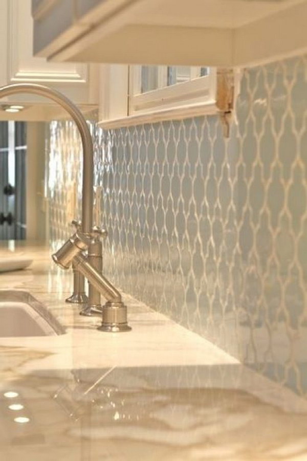 Pale Blue Tile Backsplash with White Grout against White Cabinets and Cream Countertops 