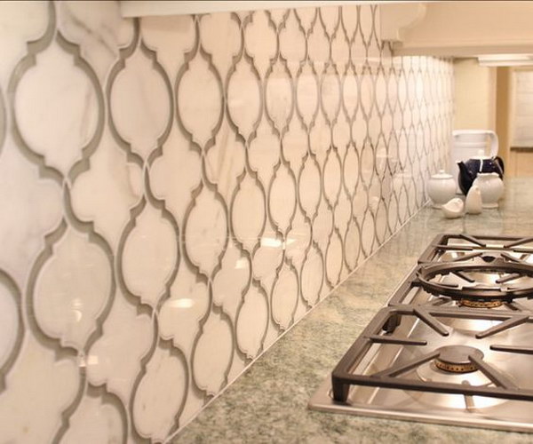 Stunning Calcutta Gold Marble and Grey Glass Backsplash with Beautiful White Cabinetry