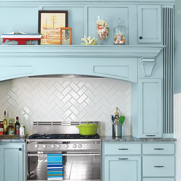 Subway Tiles Backsplash in a Herringbone Pattern with Blue Cabinets