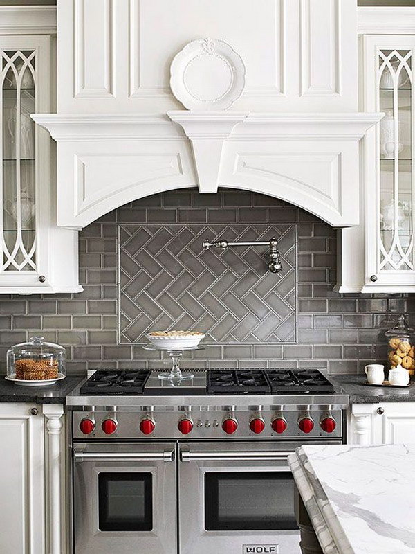 Grey Herringbone Subway Tile Backsplash Works with the Stainless Stove against White Cabinetry  