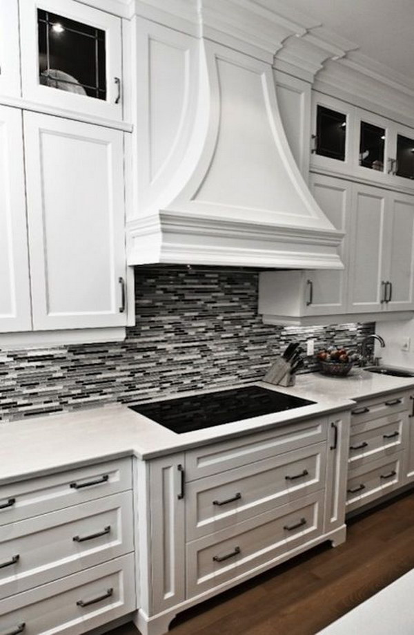 Black or Grey Linear Glass Tile Backsplash with Crisp White Cabinetry and Marble Countertops  