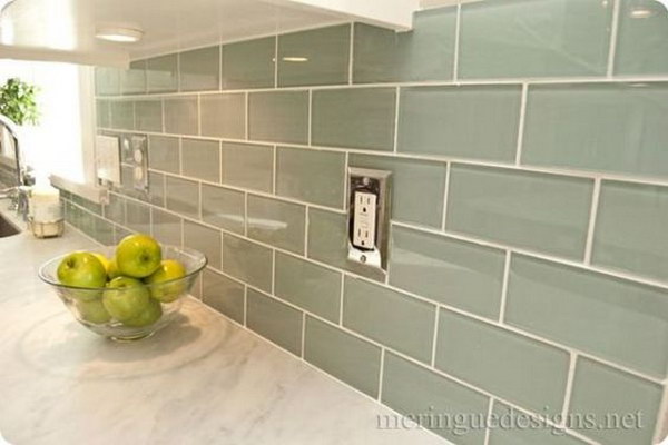 Soft Turquoise Glass Subway Tile against the Carrera Marble Countertops 