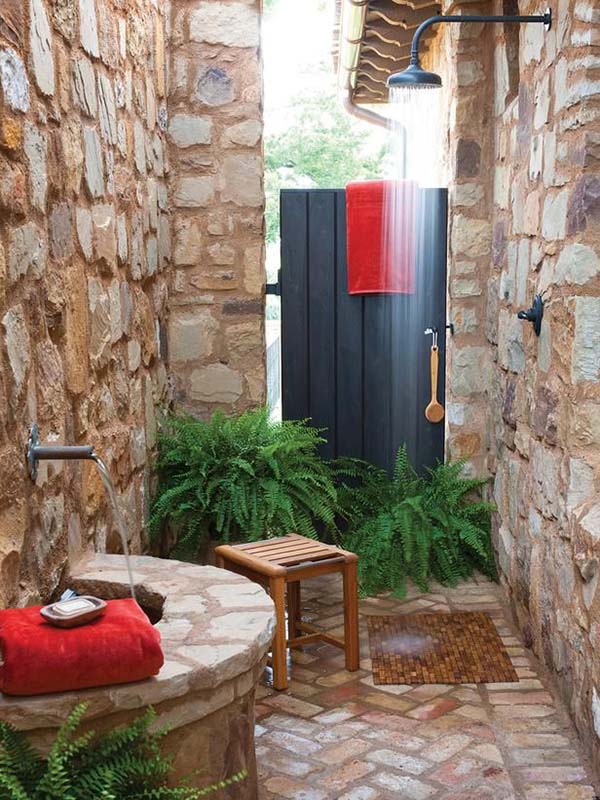 Stone Walled Outdoor Shower With Wood Stool. 