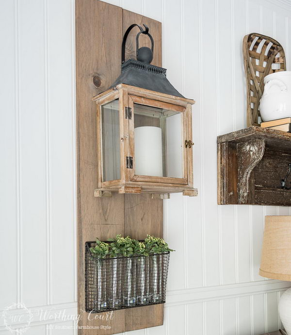 Farmhouse Style Lantern Hanging and Wire Basket Filled with Vases and Sprigs of Greenery. 