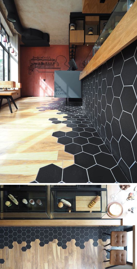 Black Hexagon Tiles Transition Into Wood Flooring. 