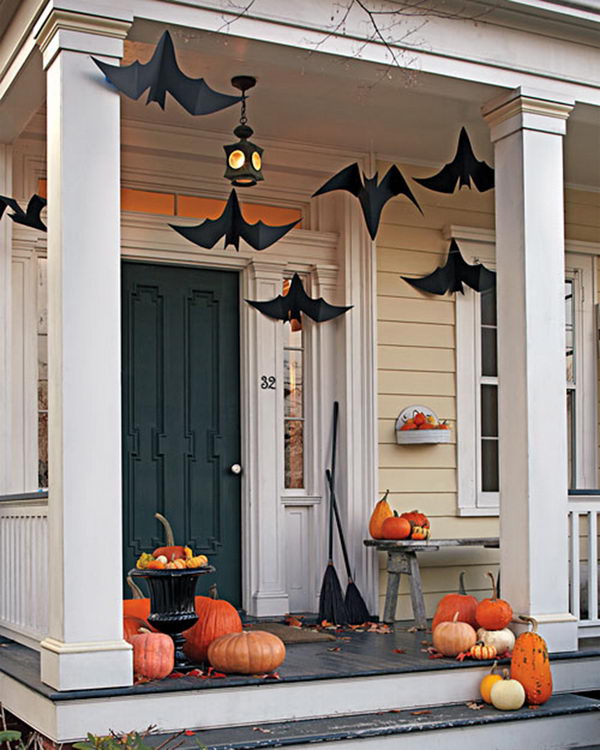 Halloween Porch Deocration Using Hanging Black Bats And Witch Brooms. 
