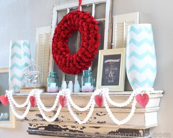 White Pom-Pom Garlands And Red Rose Wreath With A Pop Of Turquoise. 